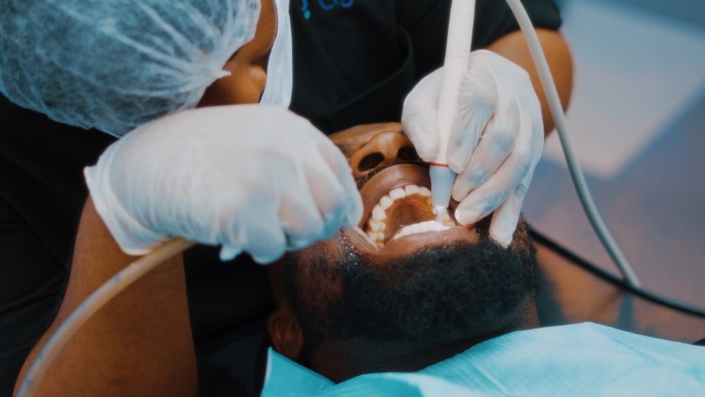 A dentist treating a patient in the chair